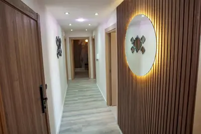 a hallway with a clock on the wall and a hallway sidx sidx sidx at Relax toute l'année Piscine chauffée in Temara