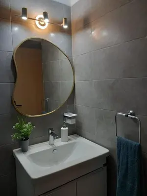 a bathroom with a sink and a mirror at Relax toute l'année Piscine chauffée in Temara