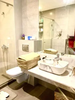 a bathroom with a sink and a toilet and a mirror at Appartementperle in Casablanca