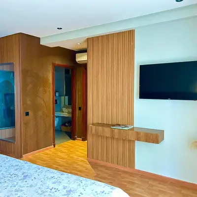 a hotel room with a television on a wall at Appartementperle in Casablanca