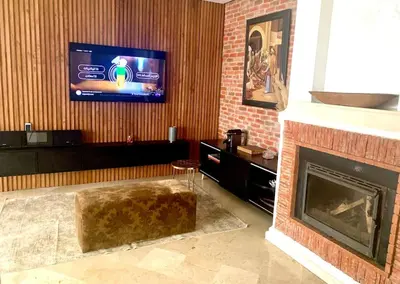 a living room with a fireplace and a flat screen tv at Appartementperle in Casablanca