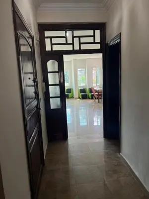 a hallway with two doors and a living room at Ait Ali in Casablanca