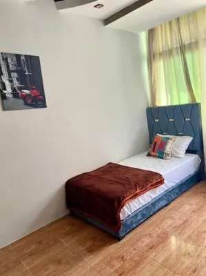 a small bed in a room with a window at Elegant and Comfortable Apartment in the Heart of Rabat in Rabat