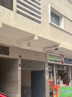 a building with a sun maker sign in front of a store at Elegant and Comfortable Apartment in the Heart of Rabat in Rabat