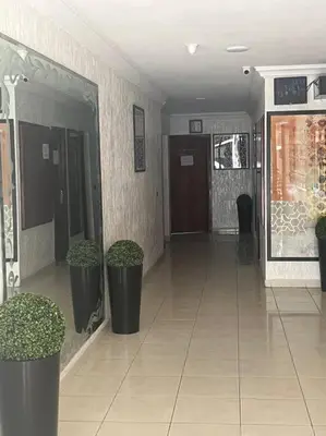a hallway with potted plants in a building at Elegant and Comfortable Apartment in the Heart of Rabat in Rabat