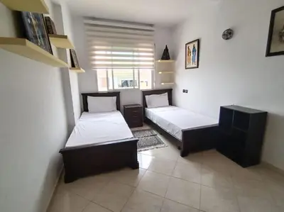 a bedroom with two beds and a window at Paradis Avec Vue Harhoura in El Harhoura