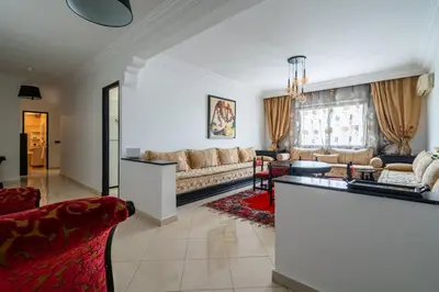 a living room with a couch and a table at Appartement Spacieux a Maarif in Casablanca
