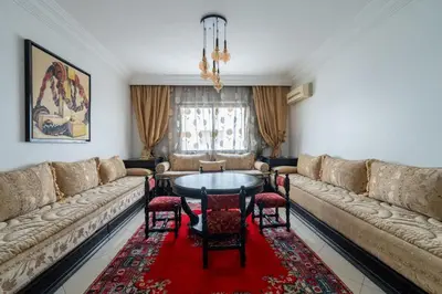a living room with a couch and a table and chairs at Appartement Spacieux a Maarif in Casablanca