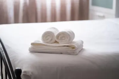 two towels sitting on top of a bed at Appartement Spacieux a Maarif in Casablanca