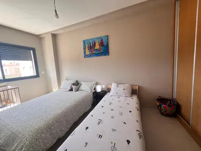 a bedroom with two beds and a window at Nice Apartment near airport mohammed V International Casablanca in Deroua