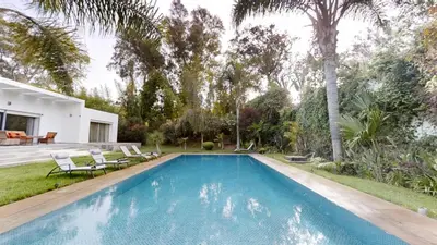 a swimming pool in the backyard of a house at Villa F- Luxury 4 suites on a 5000sqm in the heart of Ambassadeurs in Rabat