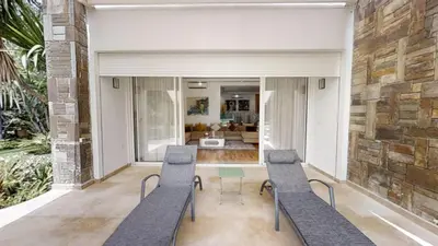 a living room with two chairs and a table at Villa 44- Superbe Villa Moderne 7 chambres, 2500m2, piscine, cinema, clim , meublee in Rabat