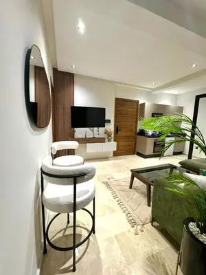 a living room with a couch and a table at Casablanca Maarif Extension Green Retreat in Casablanca