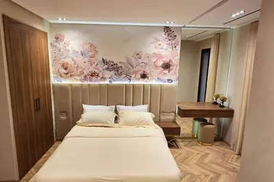 a bedroom with a bed with a painting on the wall at studio ghandi in Casablanca