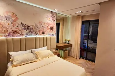 a bedroom with a bed with a flower painting on the wall at studio ghandi in Casablanca
