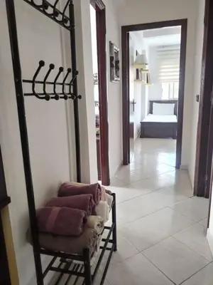 a room with a chair and a mirror and a bedroom at Paradis Avec Piscine et Vue sur mer Harhoura in Temara