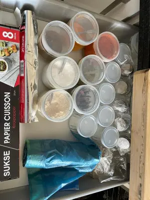 a drawer filled with lots of dishes in a refrigerator at Grand appartement vue sur piscine Bouznika in Kasba Bou Hamira