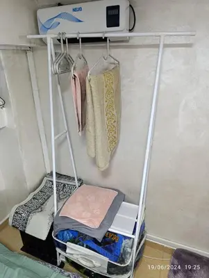 a clothes rack with towels on it in a room at Alone Studio in Casablanca