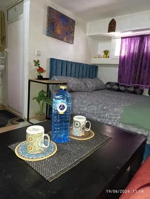 a table with two cups and a bottle of water at Alone Studio in Casablanca
