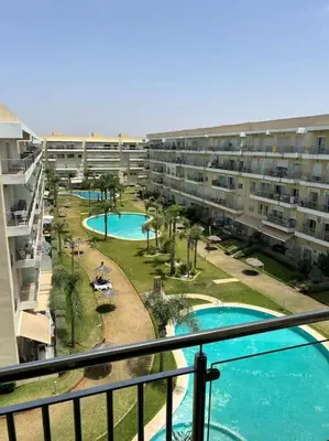 a view from a balcony of an apartment complex with two pools at Logement paisible in Bouznika