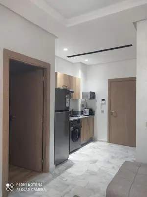 a kitchen with a refrigerator and a stove top oven at Ocean Park Zenata City Eco in Casablanca