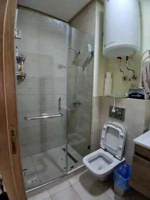 a bathroom with a shower with a toilet and a sink at Ocean Park Zenata City Eco in Casablanca