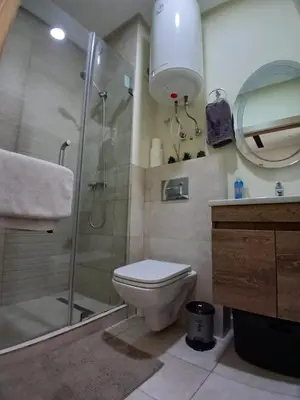 a bathroom with a shower and a toilet and a sink at Ocean Park Zenata City Eco in Casablanca