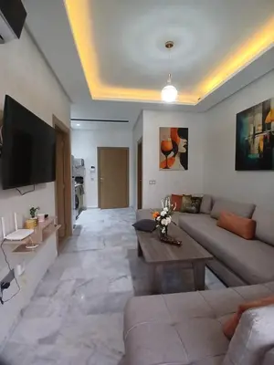 a living room with a couch and a table at Ocean Park Zenata City Eco in Casablanca