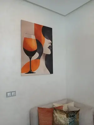 a painting of a woman with a glass of wine at Ocean Park Zenata City Eco in Casablanca
