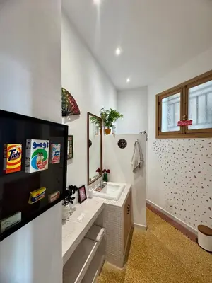 a white bathroom with a sink and a mirror at Loft art-déco centre-ville Casa in Casablanca
