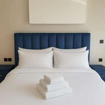a bed with three towels sitting on top of it at Cosy ensoleillé 3 CH - central et proche du train et tramway in Casablanca