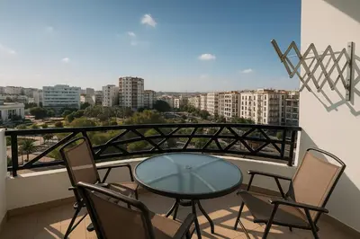 a table and chairs on a balcony with a view at Cosy ensoleillé 3 CH - central et proche du train et tramway in Casablanca