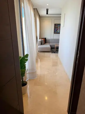 a hallway with a living room with a couch at Studio Iris CFC in Casablanca