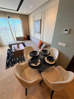 a living room with a table and chairs and a couch at Studio Iris CFC in Casablanca