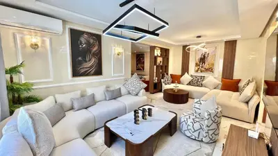 a living room with a couch and a table at N30 Élégance et Confort à La Corniche Rabat - Appartement de Luxe Essabah in Rabat