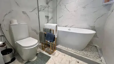 a bathroom with a white tub and a toilet at N30 Élégance et Confort à La Corniche Rabat - Appartement de Luxe Essabah in Rabat