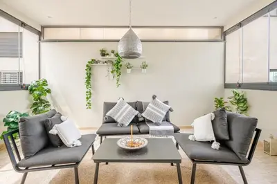 a living room with two couches and a table at Sojori CFC fibre et parking in Casablanca