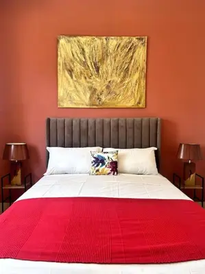 a bed with a red blanket on top of it at Appartement en résidence privée in Casablanca