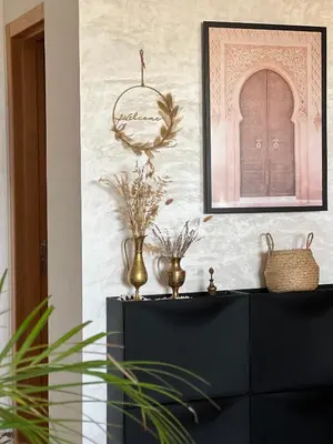 a black dresser with vases and a picture on a wall at Charm and Calm - Superbe appartement de luxe - Dahomy Beach - Bahia Beach in Bouznika