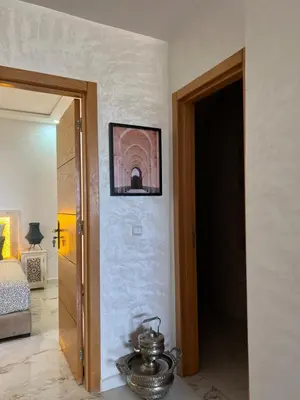a room with a door open to a room with a bed at Charm and Calm - Superbe appartement de luxe - Dahomy Beach - Bahia Beach in Bouznika