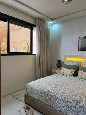 a bedroom with a bed and a window at Charm and Calm - Superbe appartement de luxe - Dahomy Beach - Bahia Beach in Bouznika