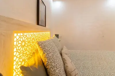 a bedroom with a bed with two pillows on it at Charm and Calm - Superbe appartement de luxe - Dahomy Beach - Bahia Beach in Bouznika