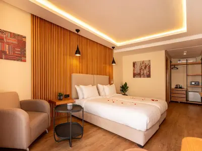 a hotel room with a large bed and a couch at Unico Hotel Maarif in Casablanca