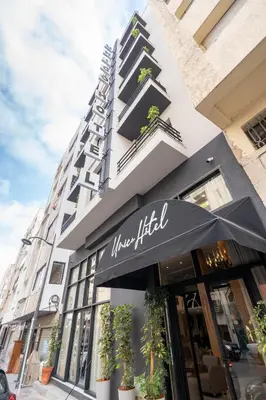 a building with a sign on the front of a store at Unico Hotel Maarif in Casablanca