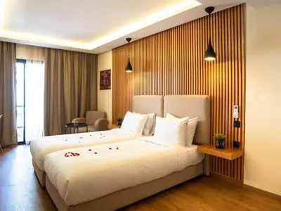a bedroom with a large white bed in a room at Unico Hotel Maarif in Casablanca