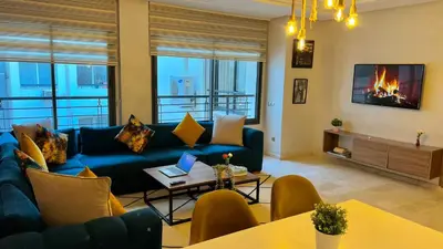 a living room with a blue couch and a fireplace at D22 Appartement haut standing au Maarif, confort in Casablanca
