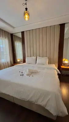 a bedroom with a large white bed with flowers on it at D22 Appartement haut standing au Maarif, confort in Casablanca