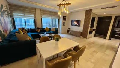 a living room with a blue couch and a table at D22 Appartement haut standing au Maarif, confort in Casablanca