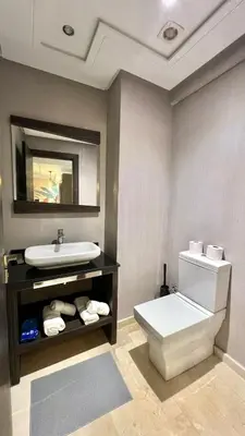 a bathroom with a white toilet and a sink at D22 Appartement haut standing au Maarif, confort in Casablanca