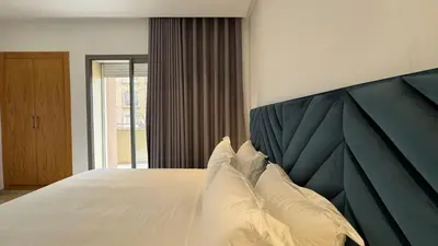 a bedroom with a large bed with white pillows at Garden View and Terrace 3BR - AppartAli Luxury Platform in Casablanca